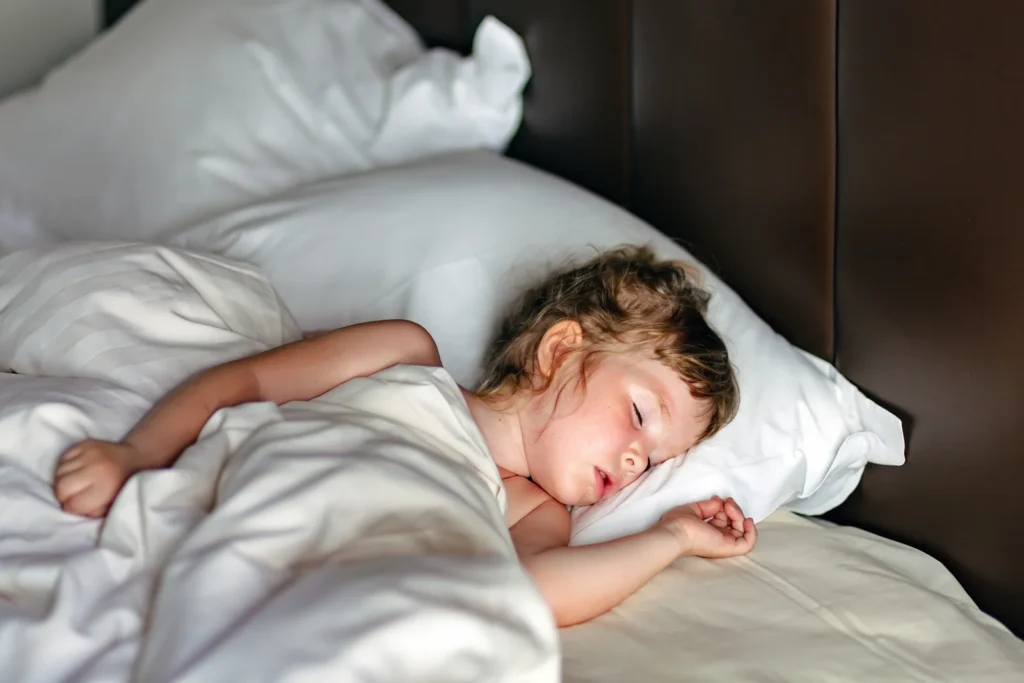 Child sleeping peacefully in bed